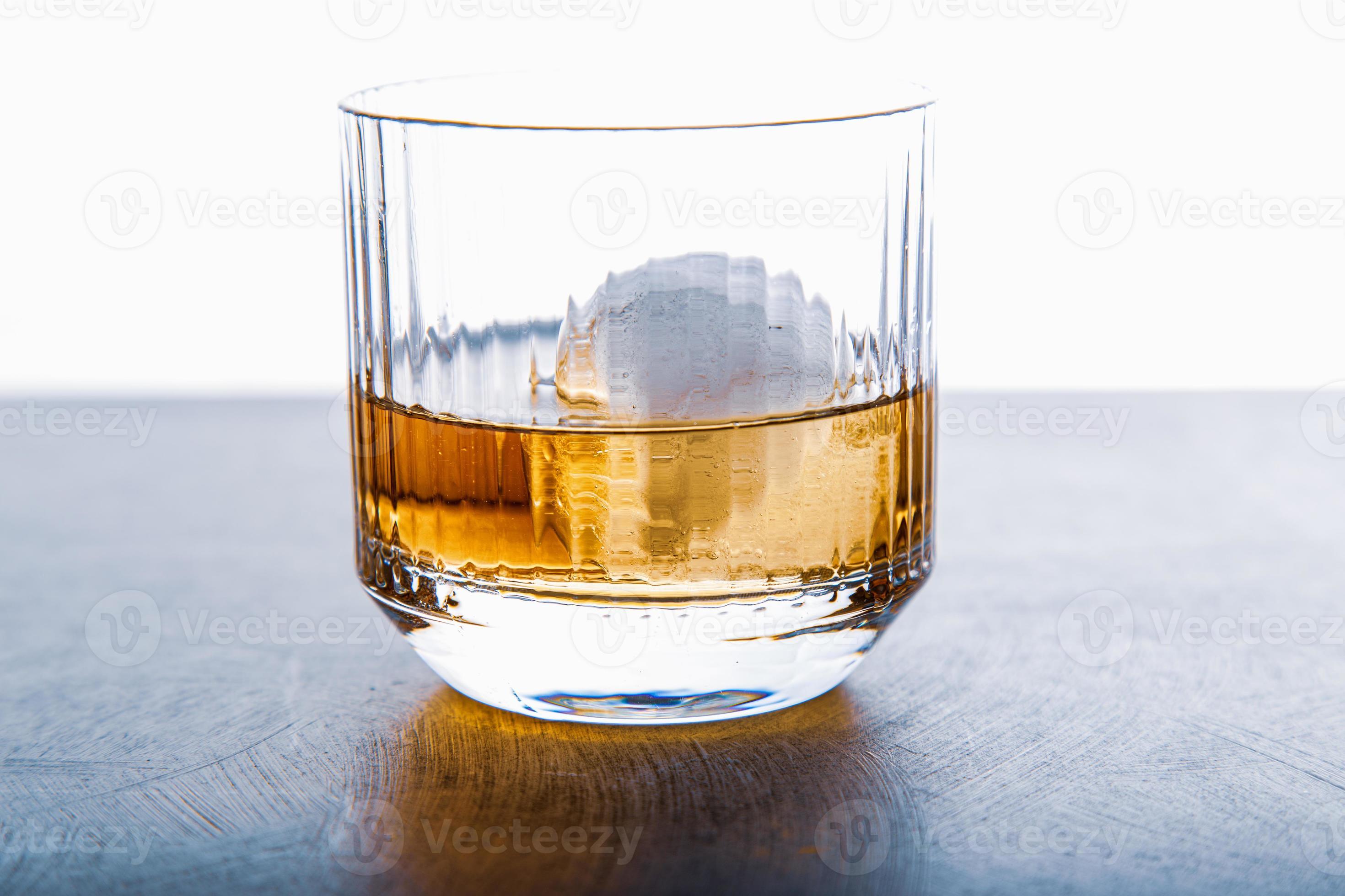 Sphere shaped ice cube and close up whiskey view from studio. 6602782 Stock Photo at Vecteezy