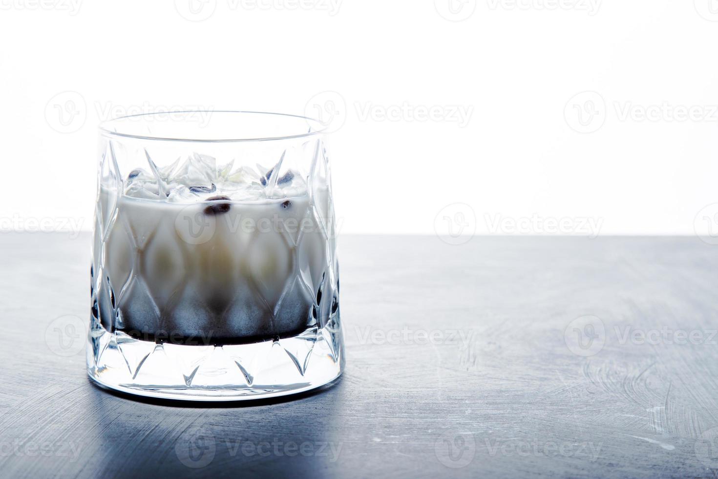 Closeup detail view of White Russian Alcoholic cocktail with copy space. photo