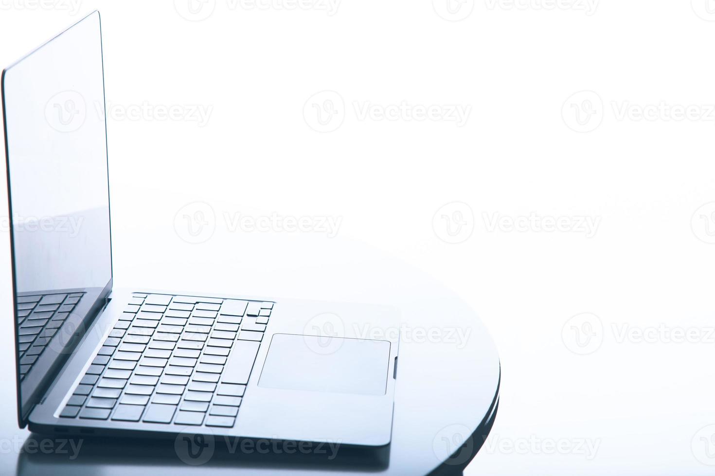 Profile side view of a laptop over white with backlit illumination. Includes copy space. photo