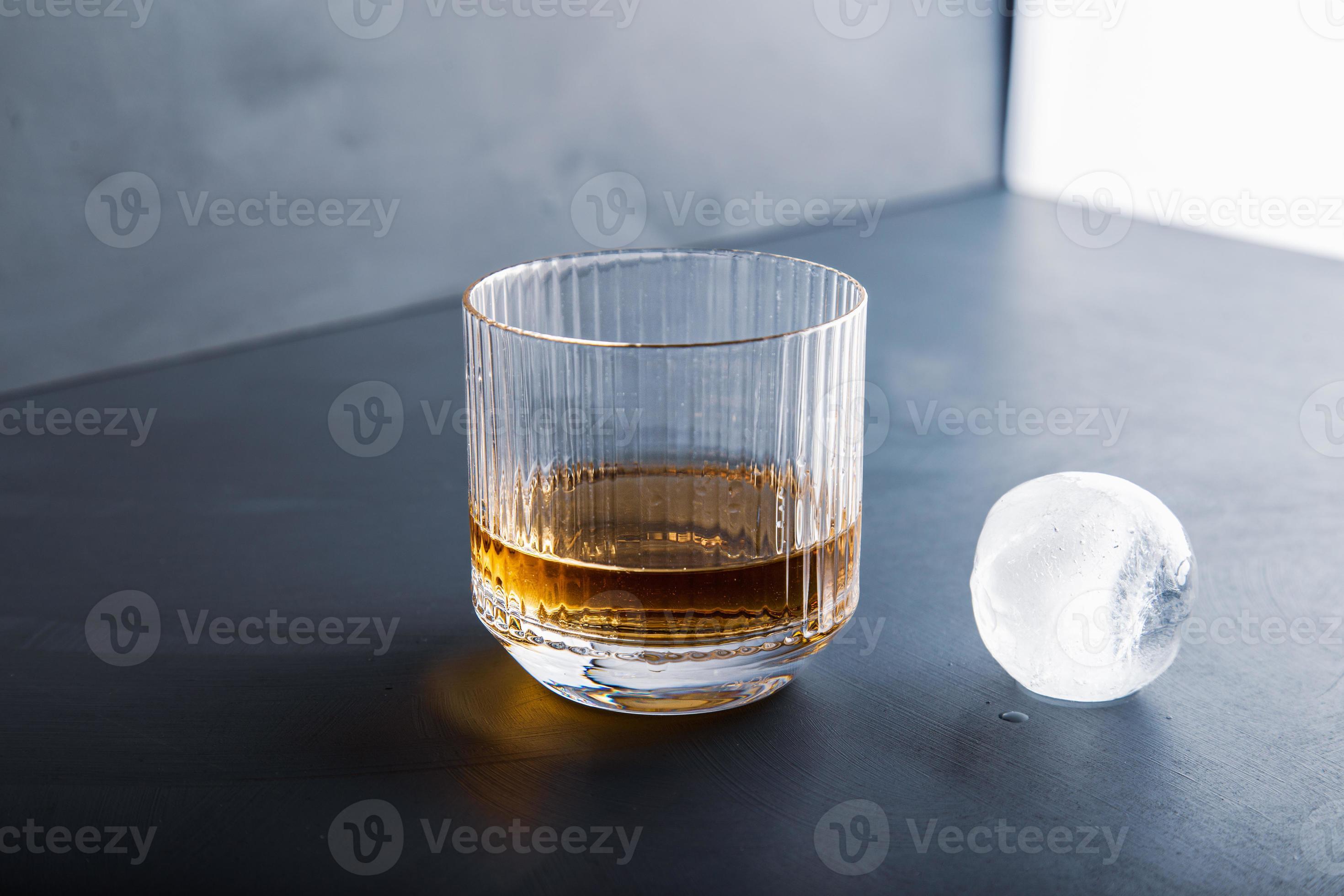 Sphere shaped ice cube and close up whiskey view from studio. 6602878 Stock  Photo at Vecteezy