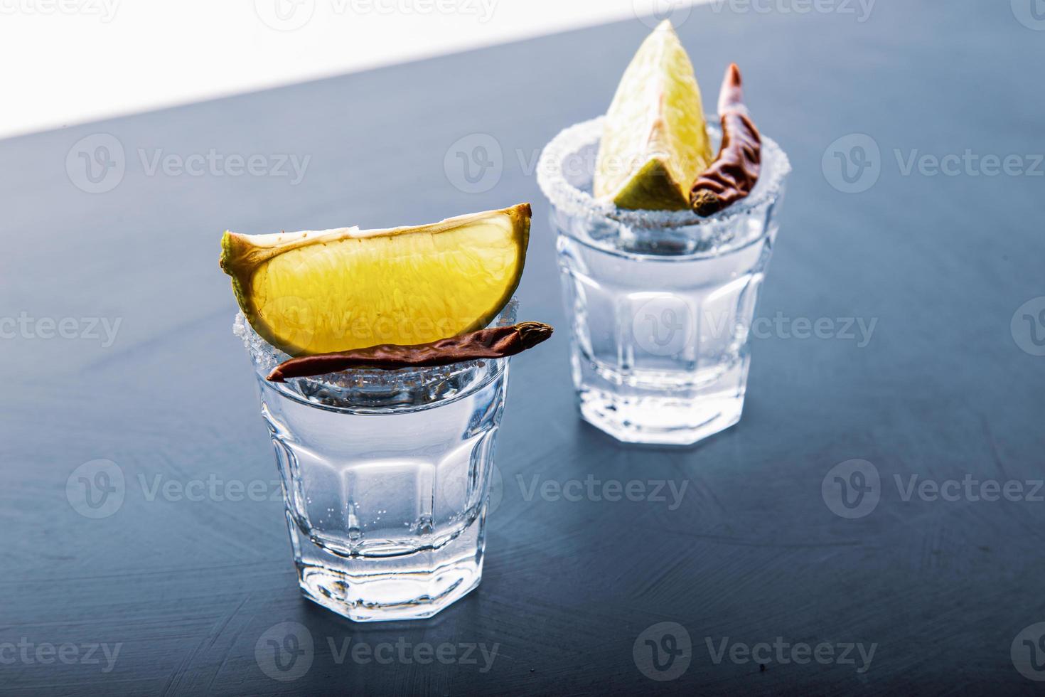Closeup detail view of tequila shots from studio with copy space. photo