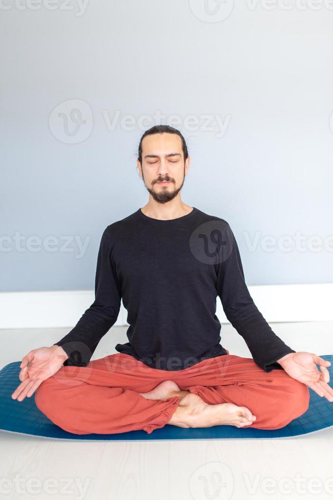 Man in peace with calm mood in meditation trance. Includes copy space, interior shot with professional performer. photo