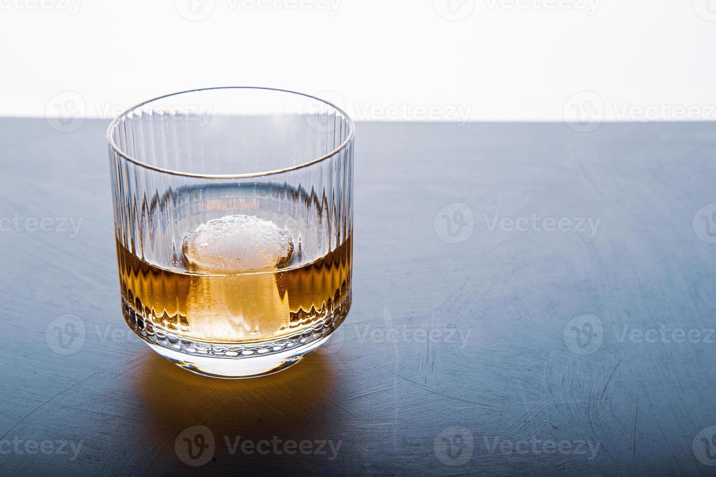 Sphere shaped ice cube and close up whiskey view from studio. 6602988 Stock Photo at Vecteezy
