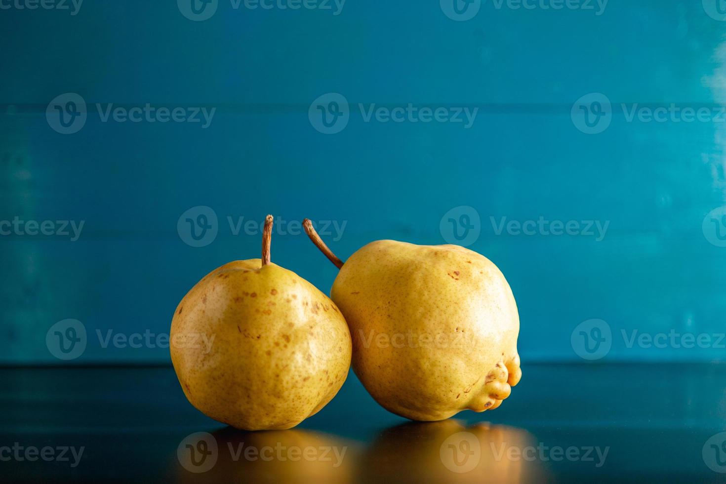 Moody styled pears view over rustic blue background with copy space. photo