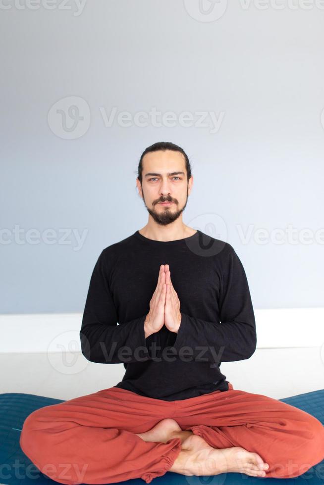 Man in peace with calm mood in meditation trance. Includes copy space, interior shot with professional performer. photo