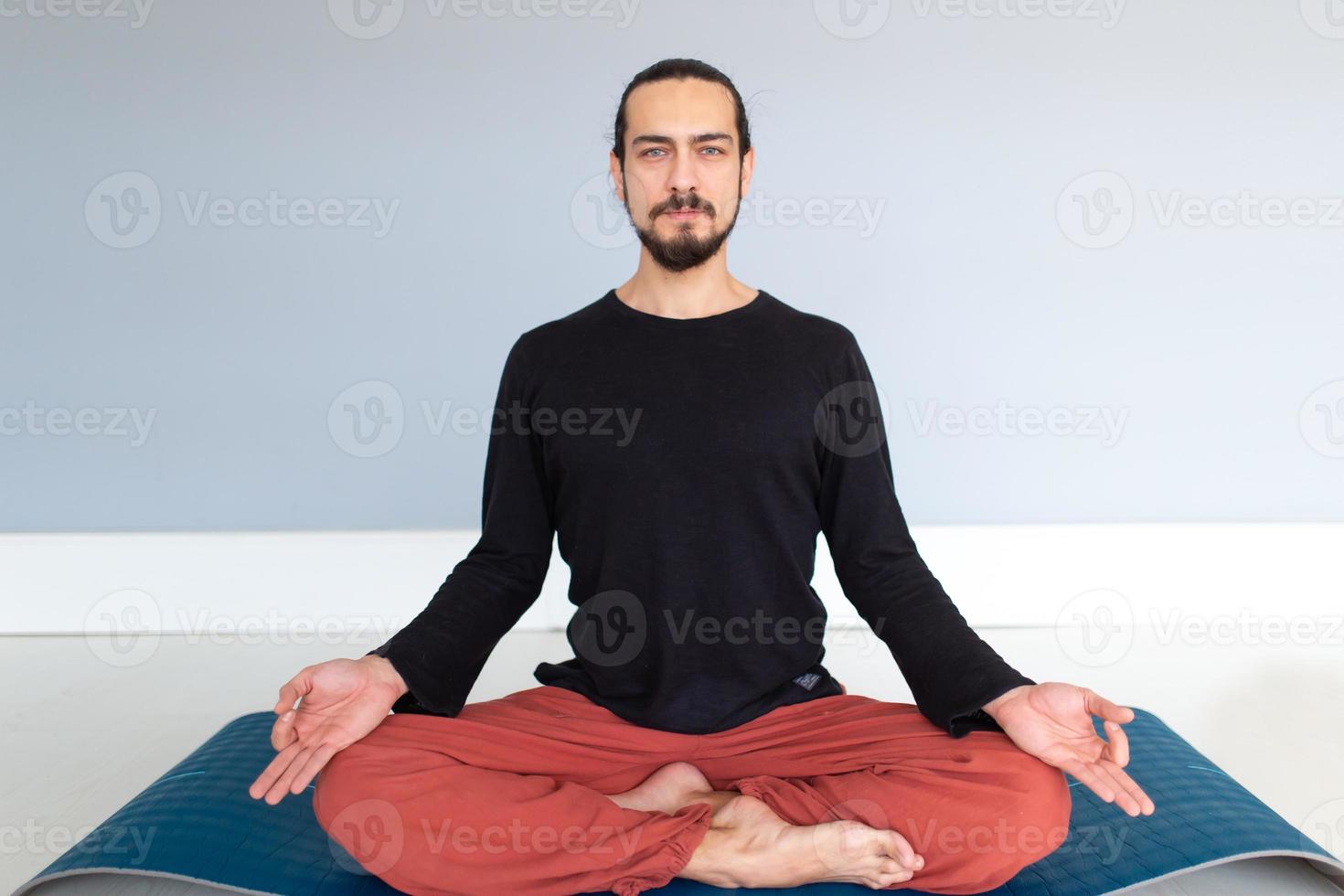 Man in peace with calm mood in meditation trance. Includes copy space, interior shot with professional performer. photo