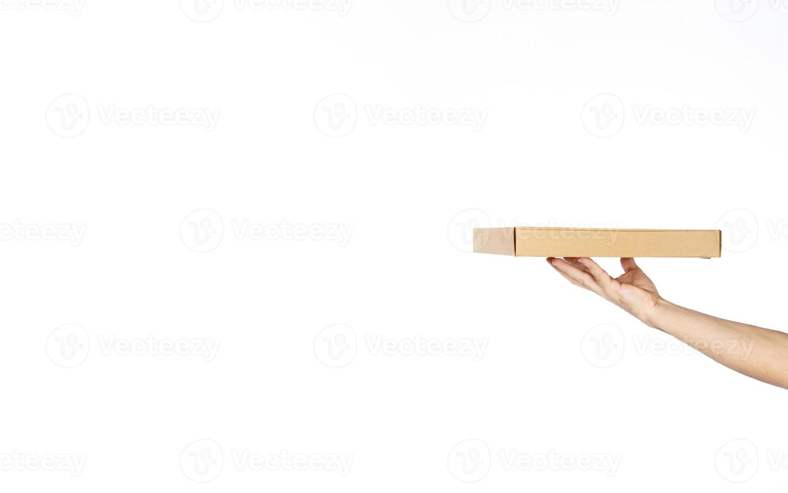 Anonymous hand is servicing pizza box or empty tray with copy space. photo