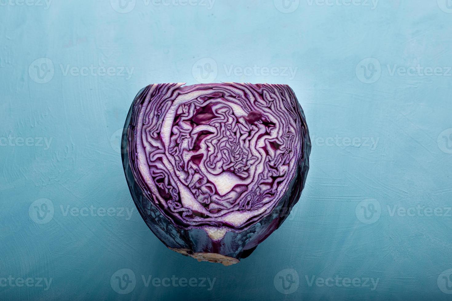 Flat lay view of purple cabbage over blue backdrop photo