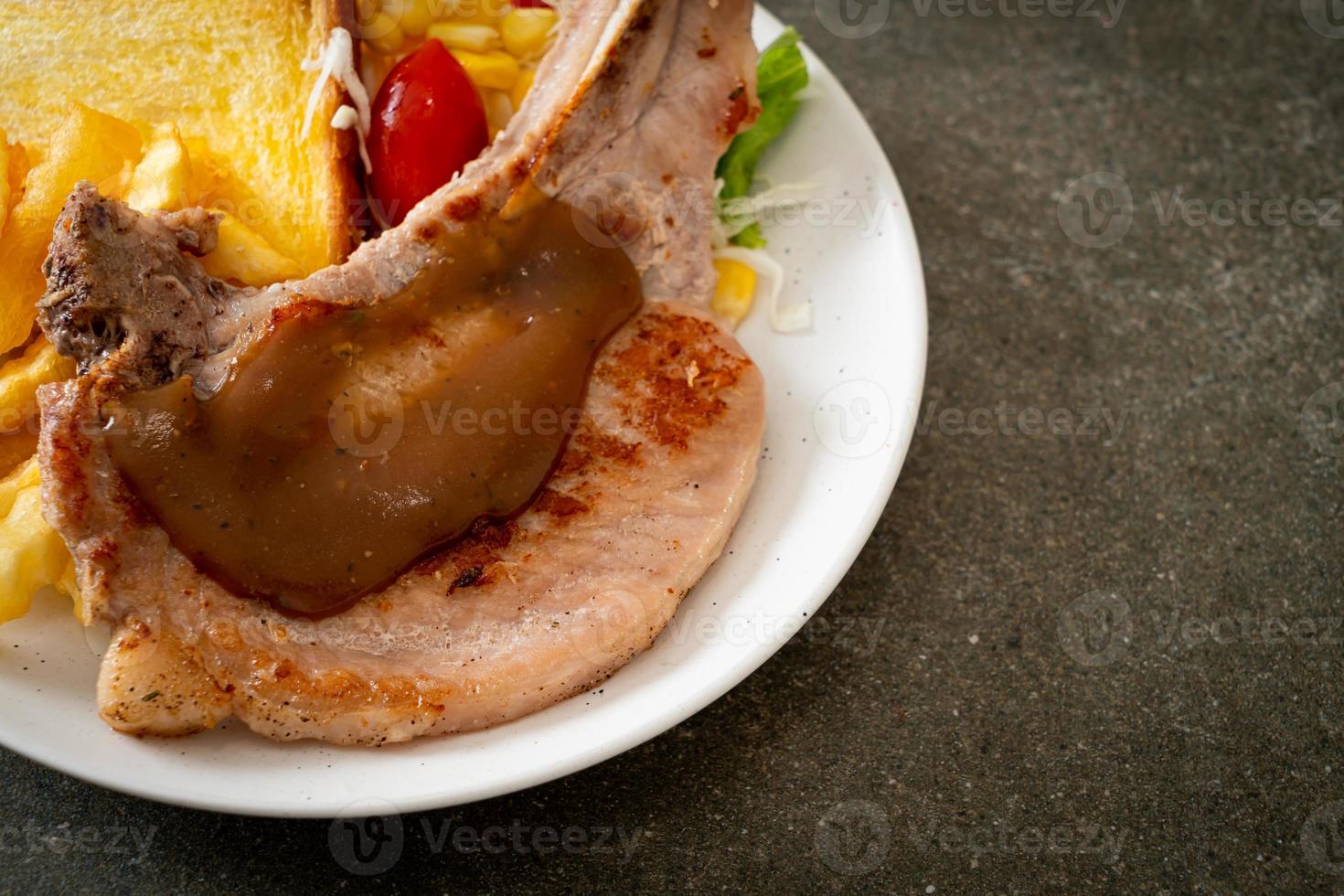 pork chop steak with chips and mini salad photo