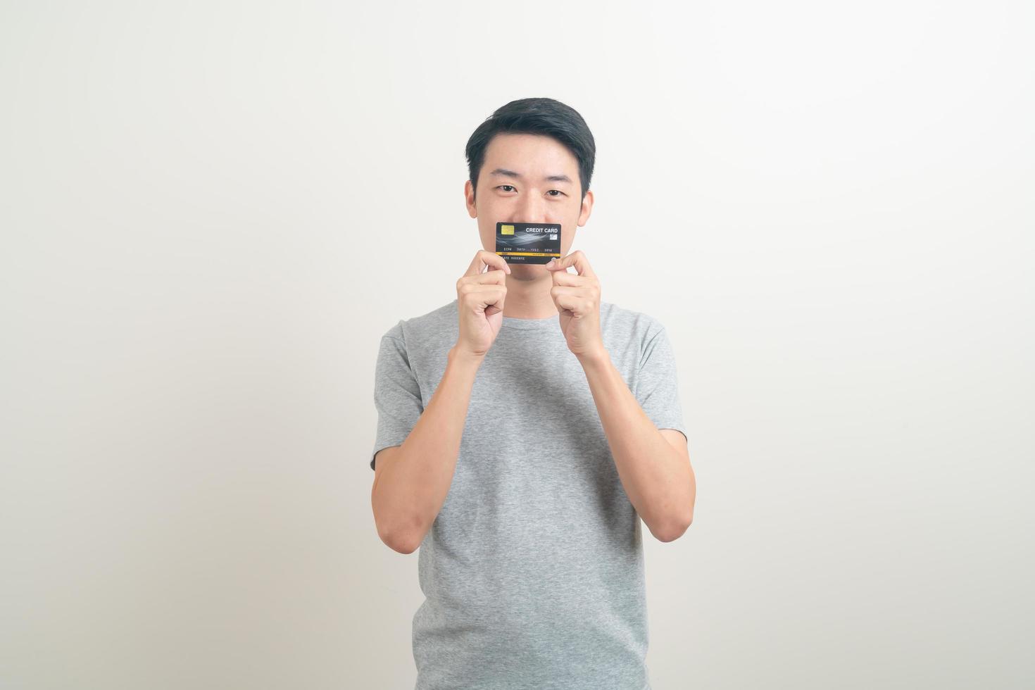 young Asian man holding credit card photo