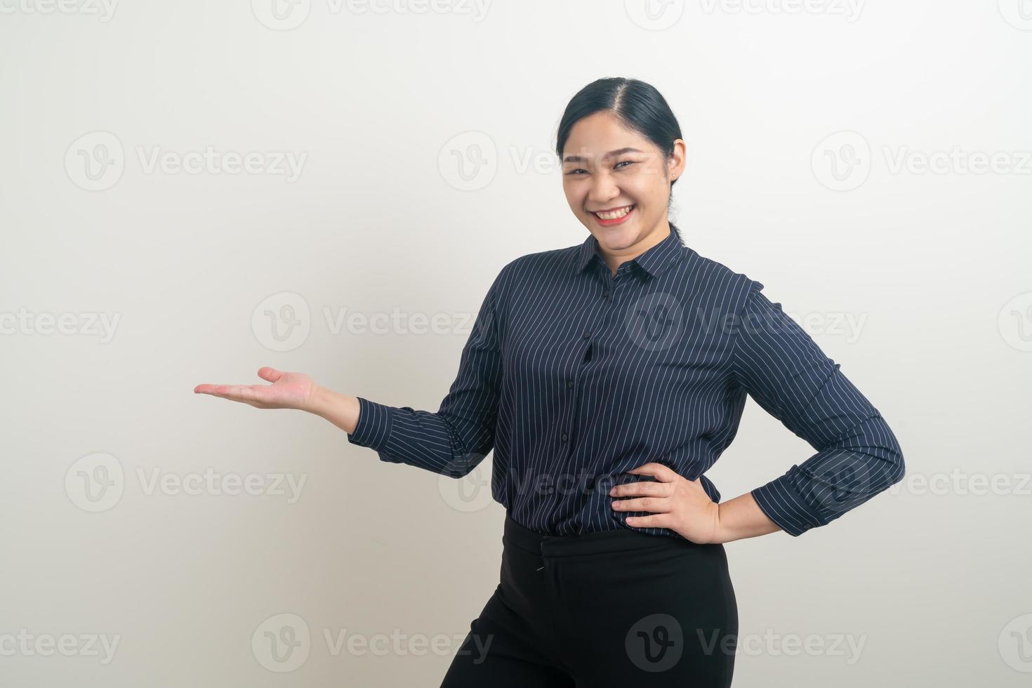 Asian woman with hand present on white wall photo