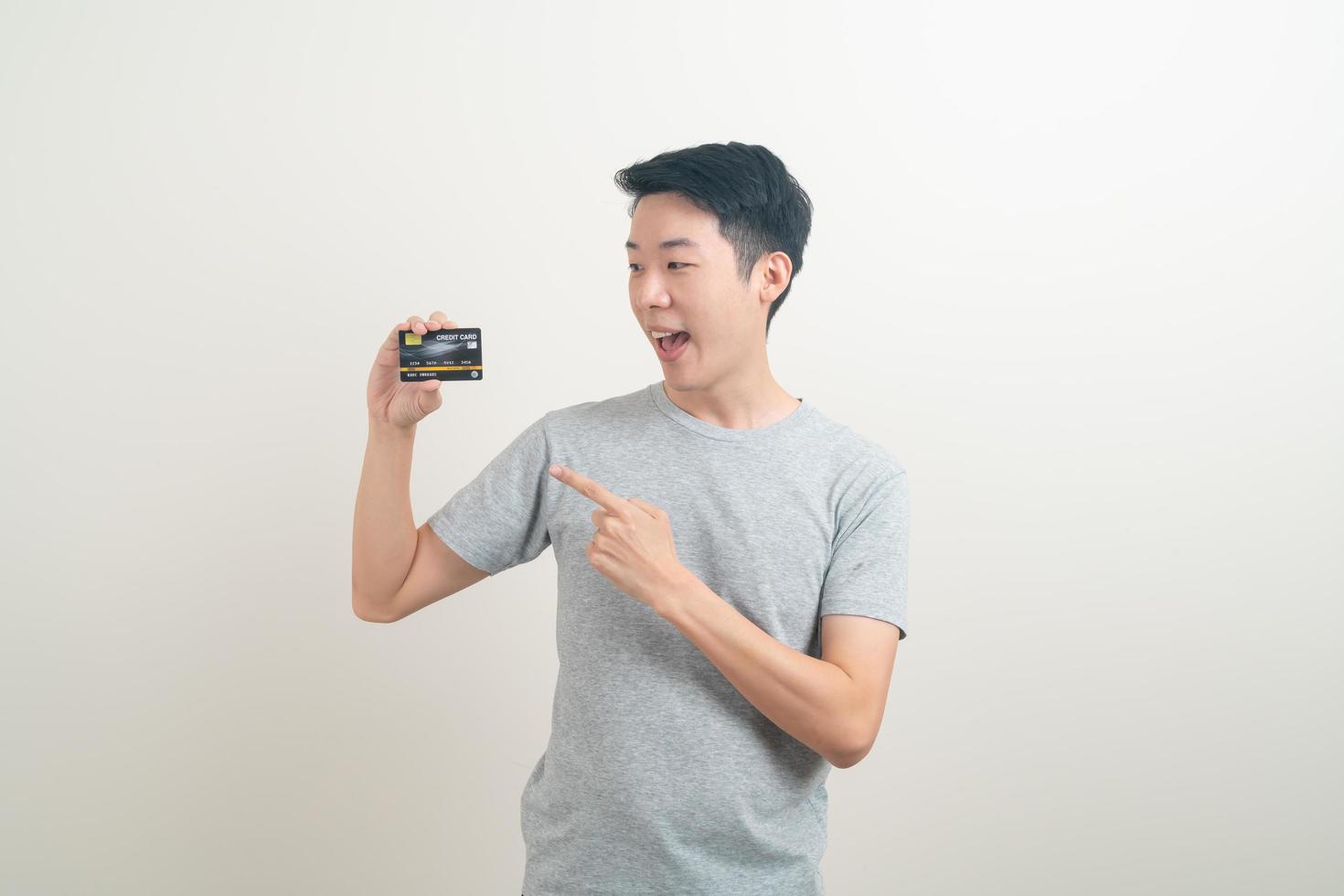 young Asian man holding credit card photo