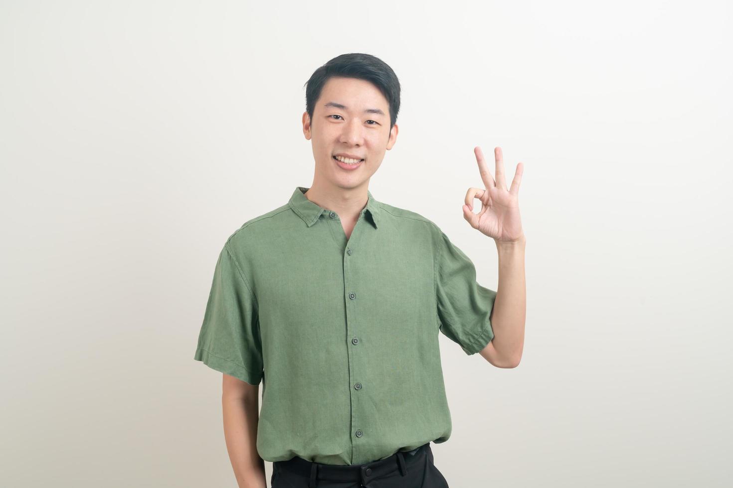 young Asian man thumbs up or ok hand sign photo