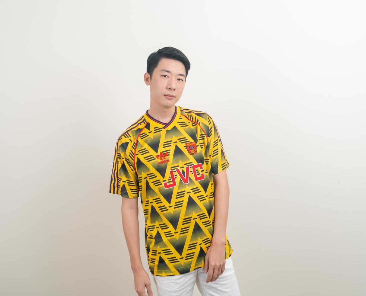 Bangkok, THAILAND - Nov 27, 2021 - Young Asian man wearing Arsenal shirt with white background. photo