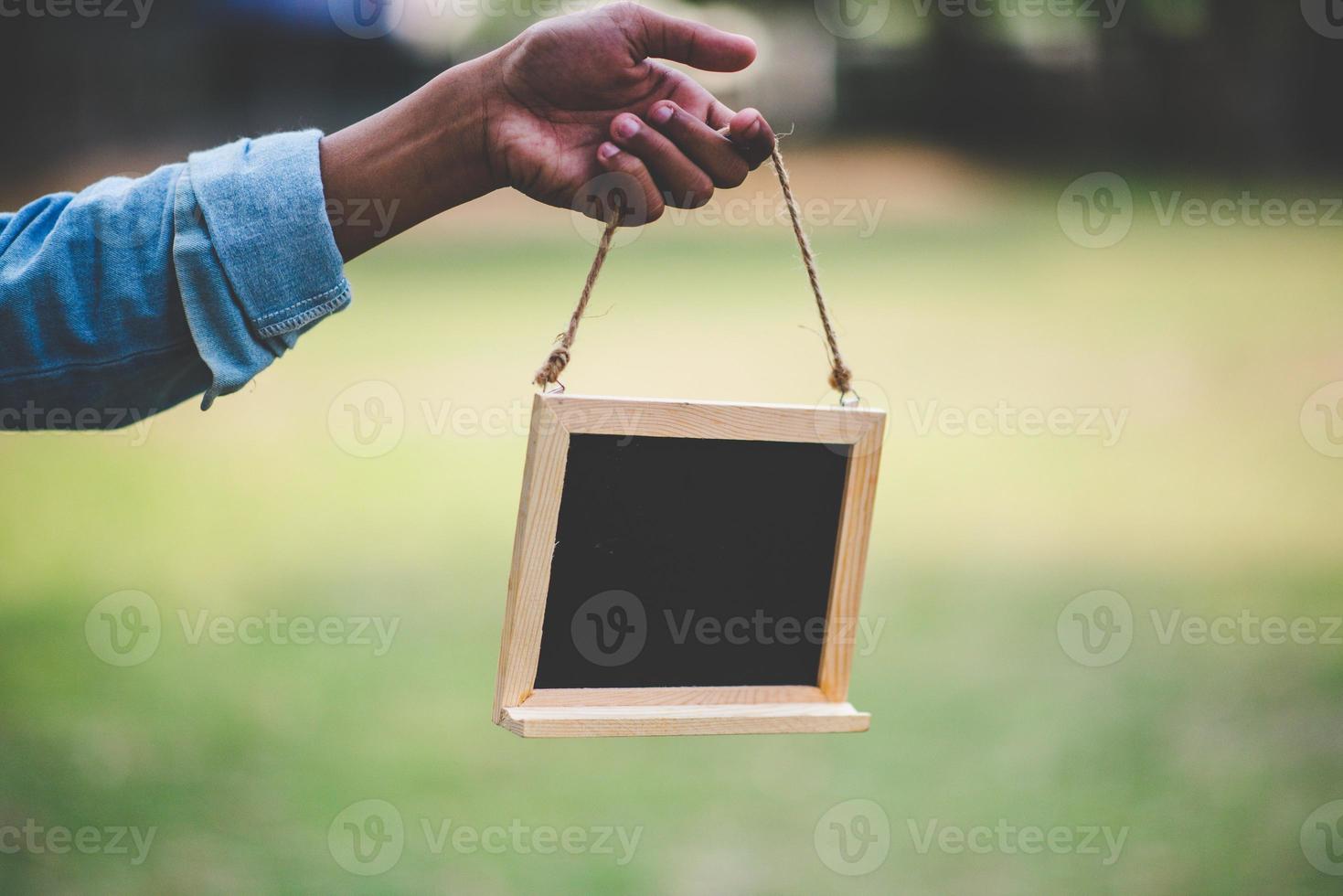 Hands and blackboard and natural green photo