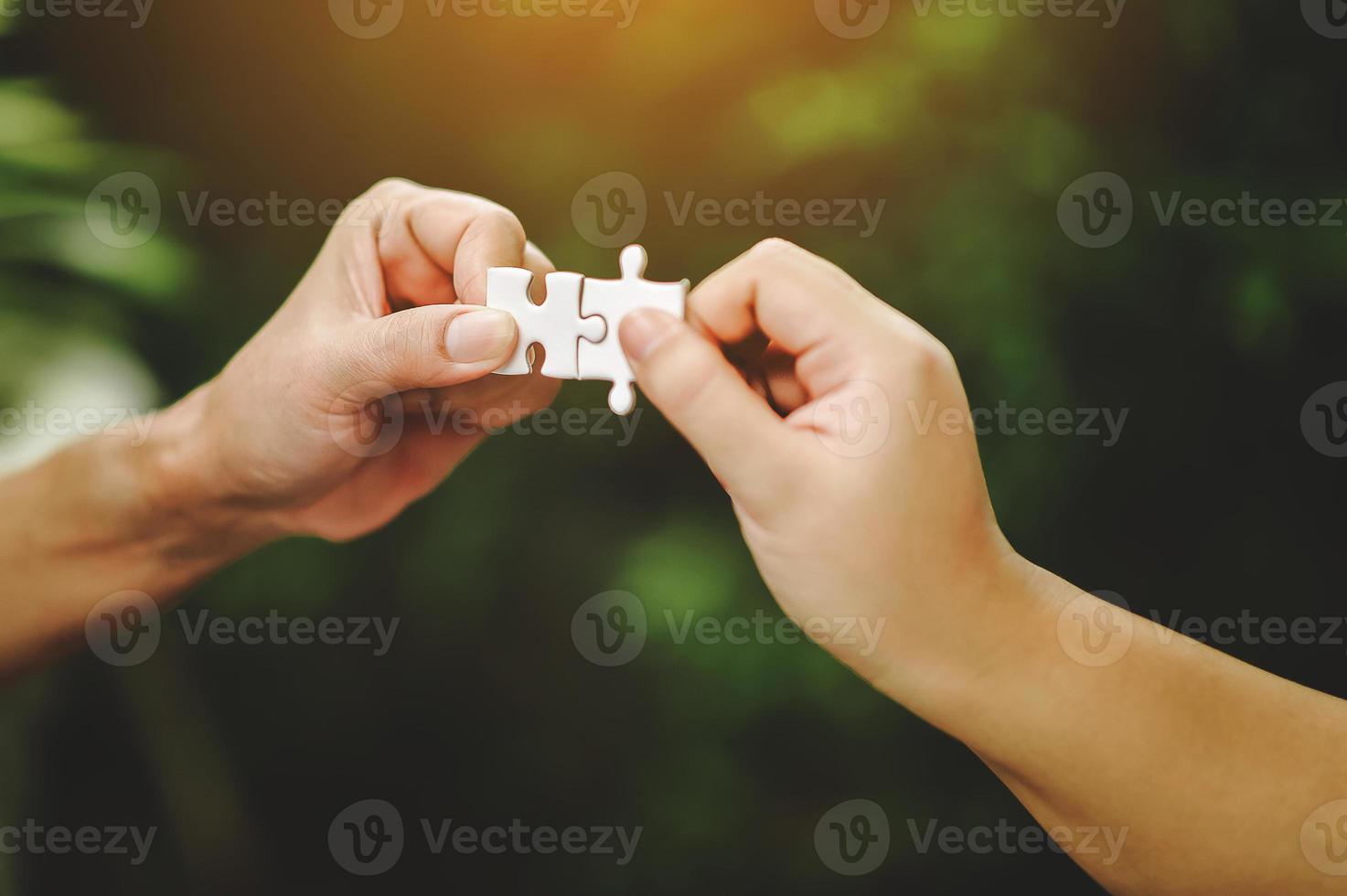 High view of businessmen solving jigsaw puzzle. Unity in the group Team work is important. photo