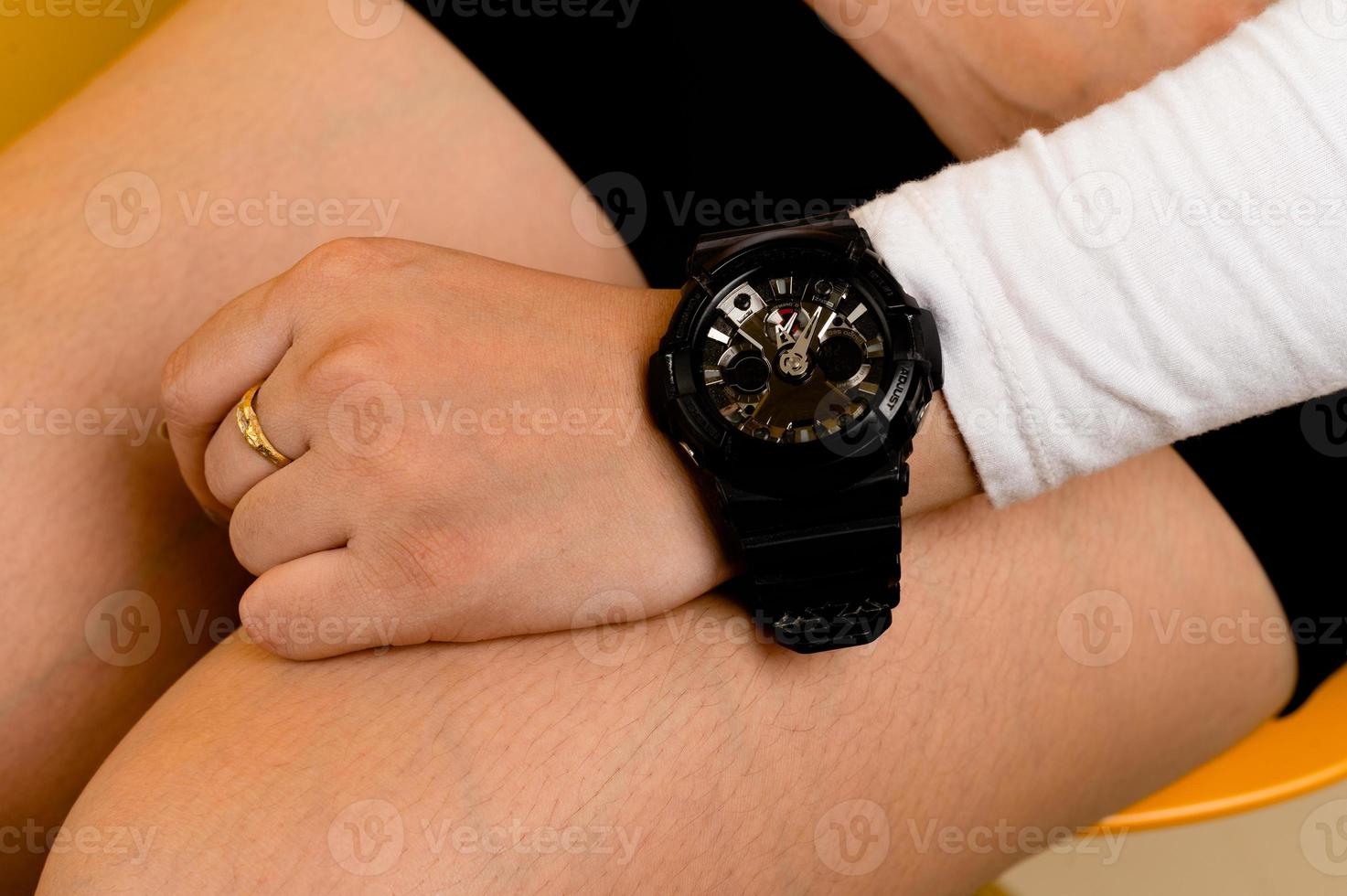 close-up photo of asian woman A person is looking at the time on her smartwatch. sitting woman