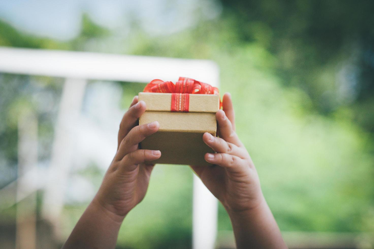 Hands and money and gift boxes photo