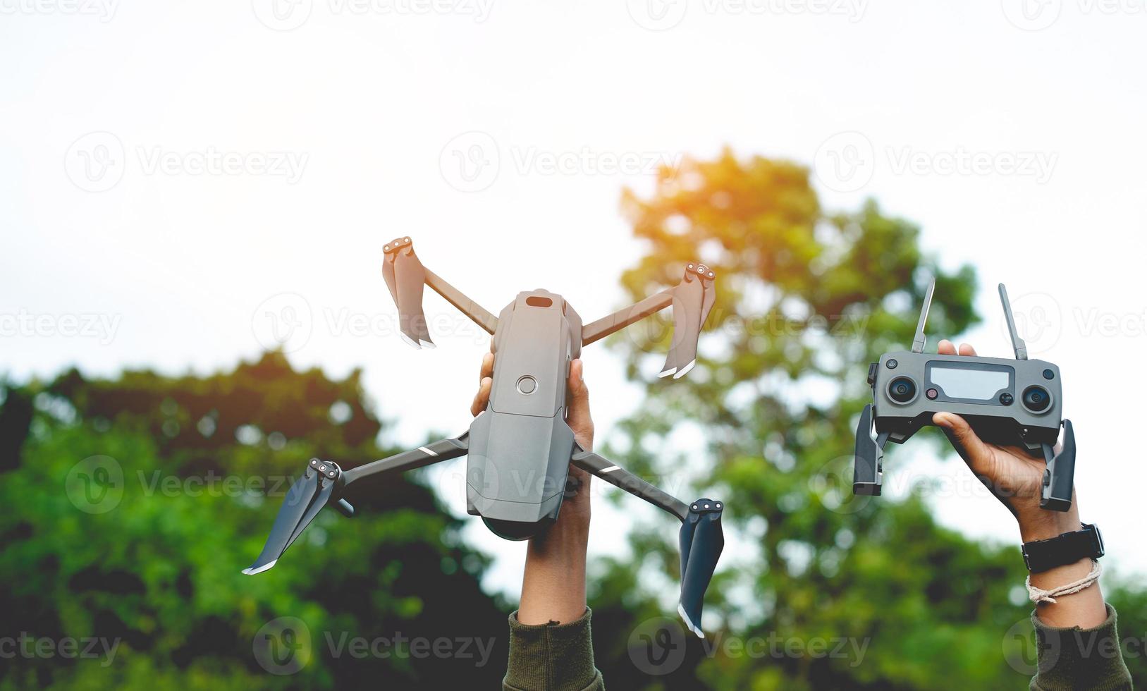 drone and my hand Get ready for an aerial survey flight. and ready for flying high-angle photography photo
