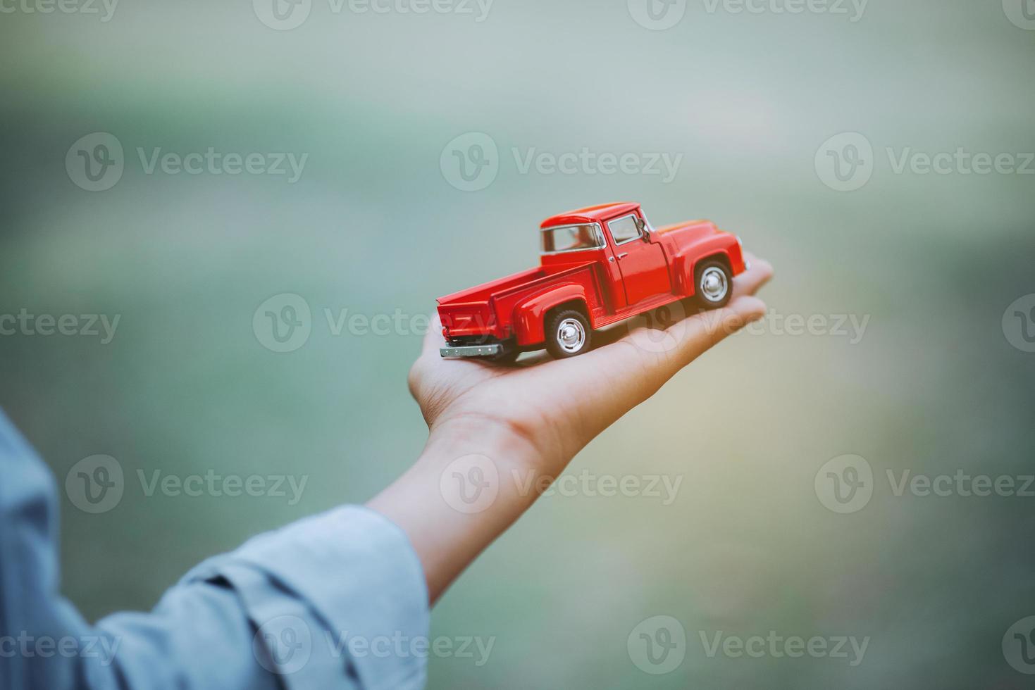 Hand and toy car in my hand. photo
