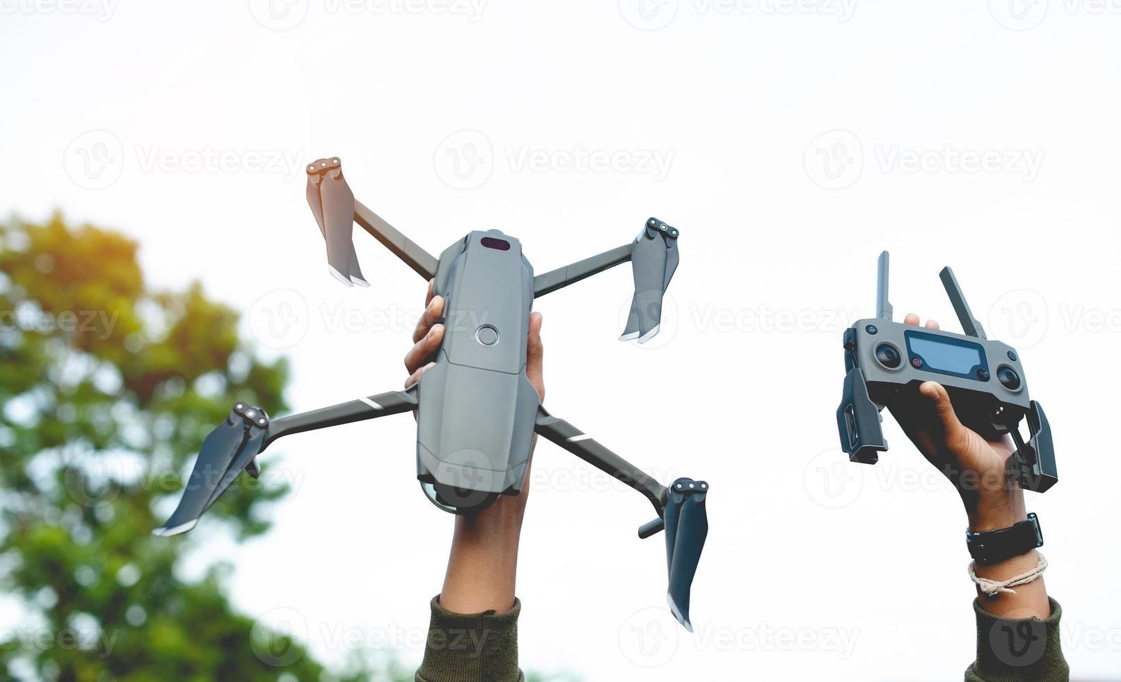 drone and my hand Get ready for an aerial survey flight. and ready for flying high-angle photography photo
