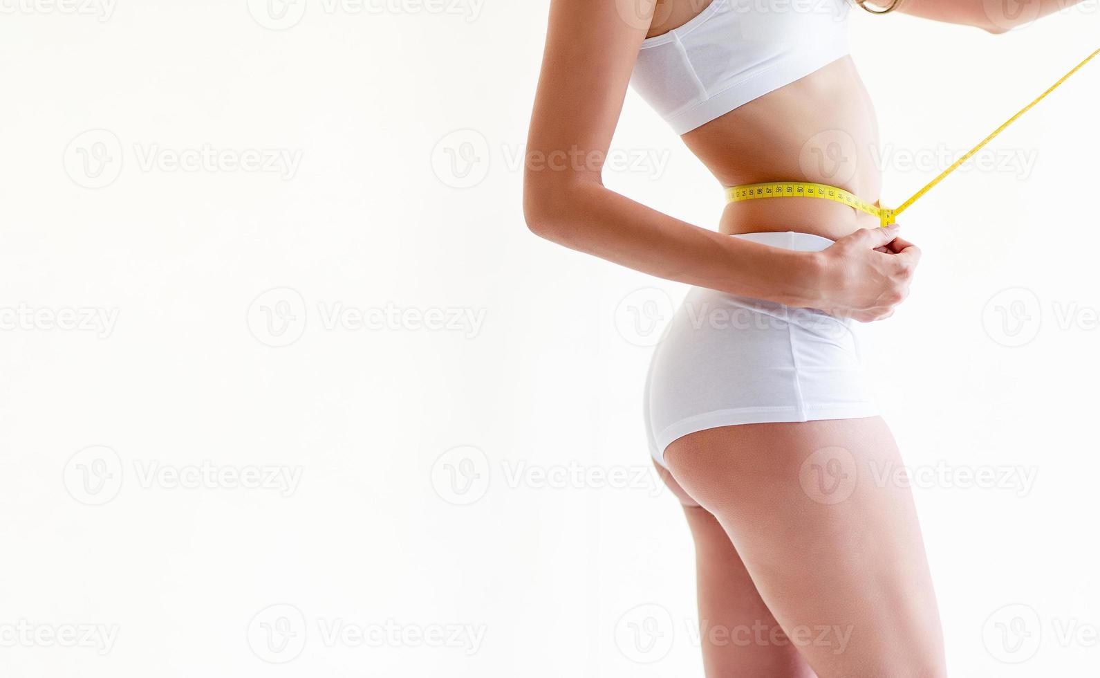 Closeup Of Tape Measure Around Woman Waist Stock Photo, Picture