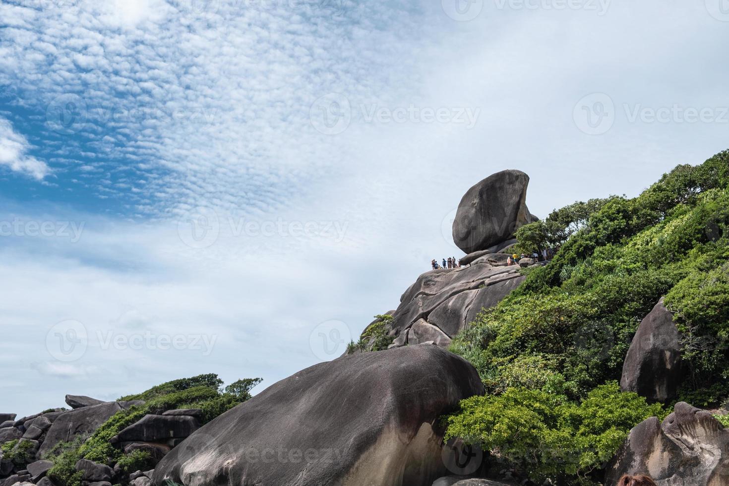 Natural big rock on peak of Similan islands with tourists travelling on sunny day photo