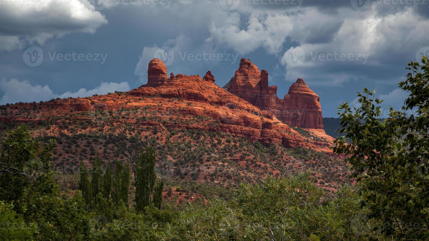 Stormy weather and bright sunshine over mountains surrounding Sedona photo