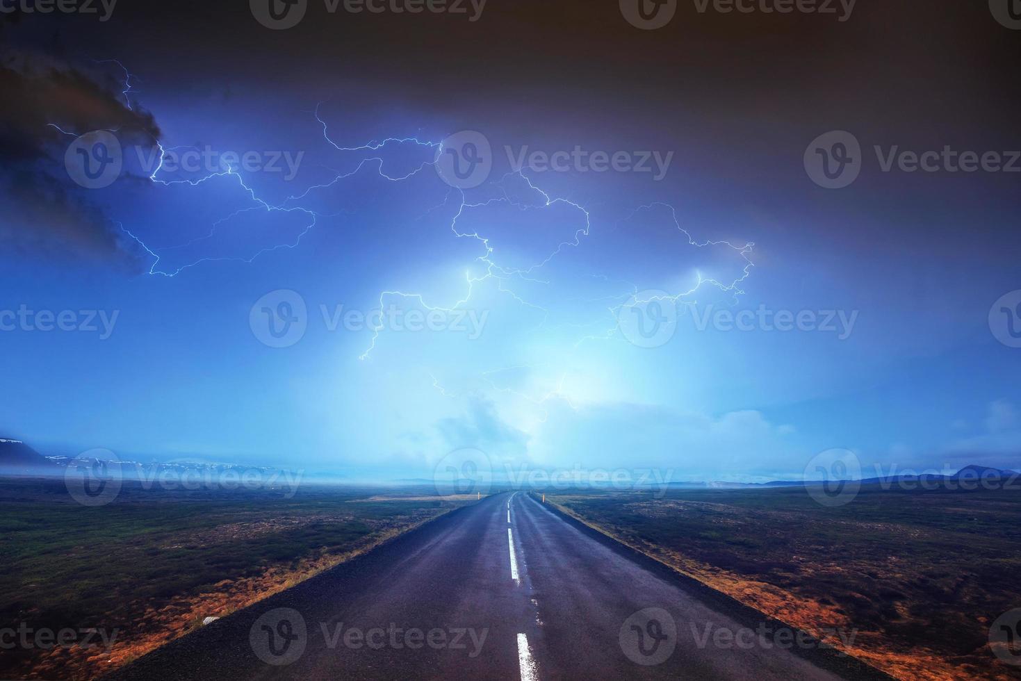 Lightning in cloudy dark sky and beautiful Asphalt road. Annual photo
