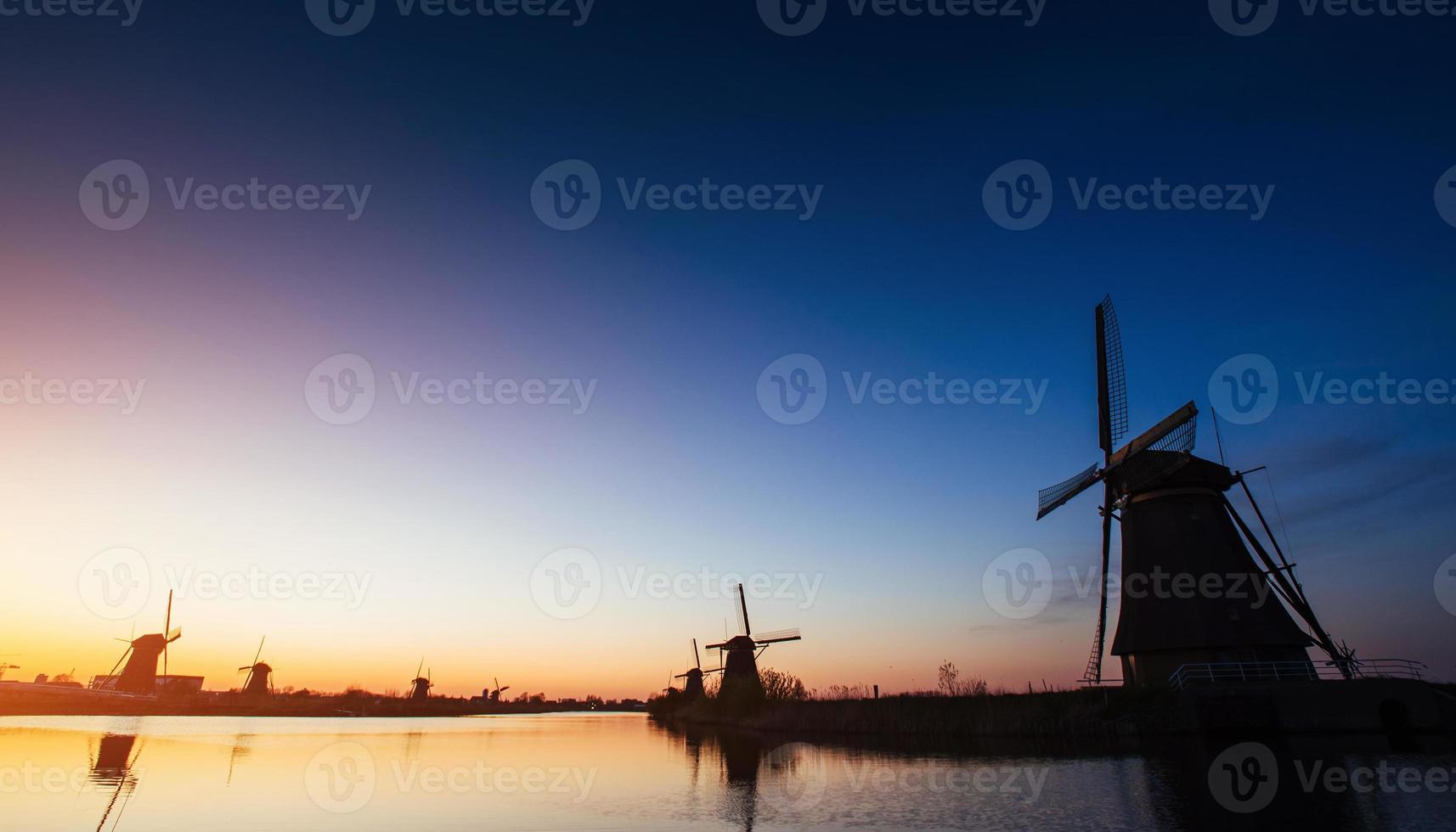 Colorful spring sunset traditional Dutch windmills canal in Rott photo