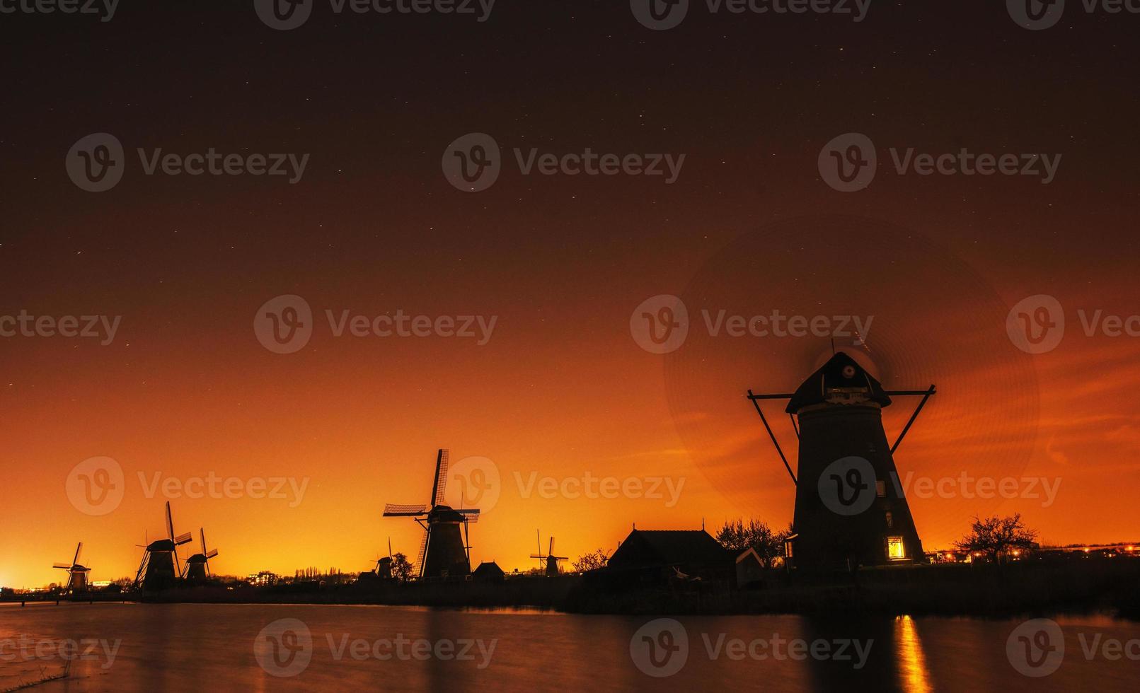 Fantastic orange sunset traditional Dutch windmills canal in Rot photo