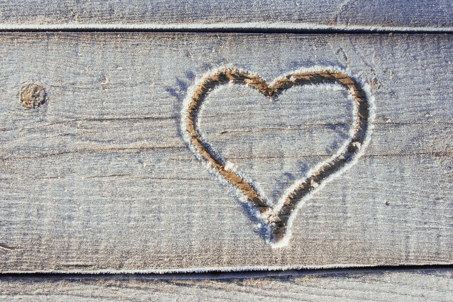 Writing on the snow. Wooden texture. photo