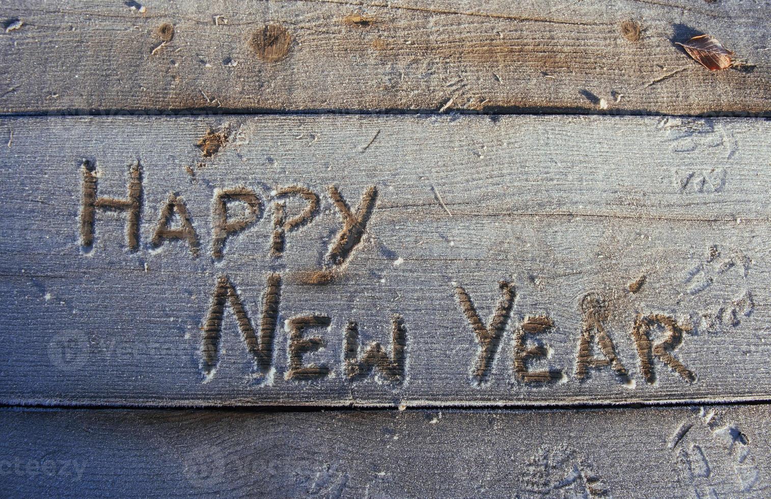 Writing on the snow. Wooden texture. photo