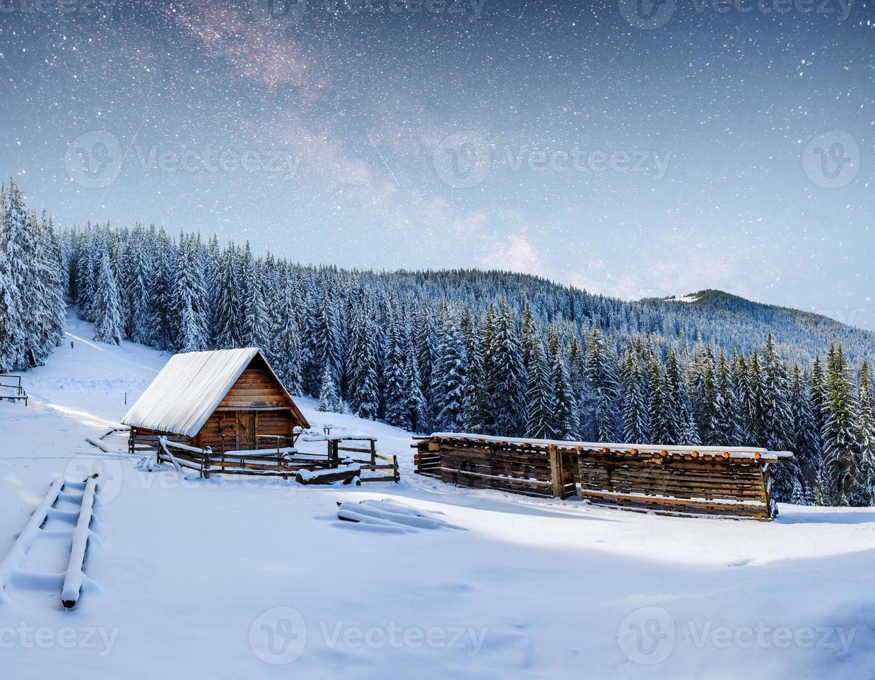 chalets in the mountains at night under the stars. photo