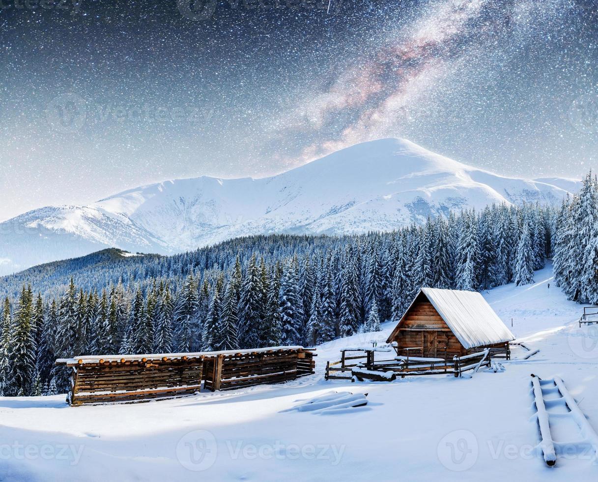 chalets in the mountains at night under the stars. photo