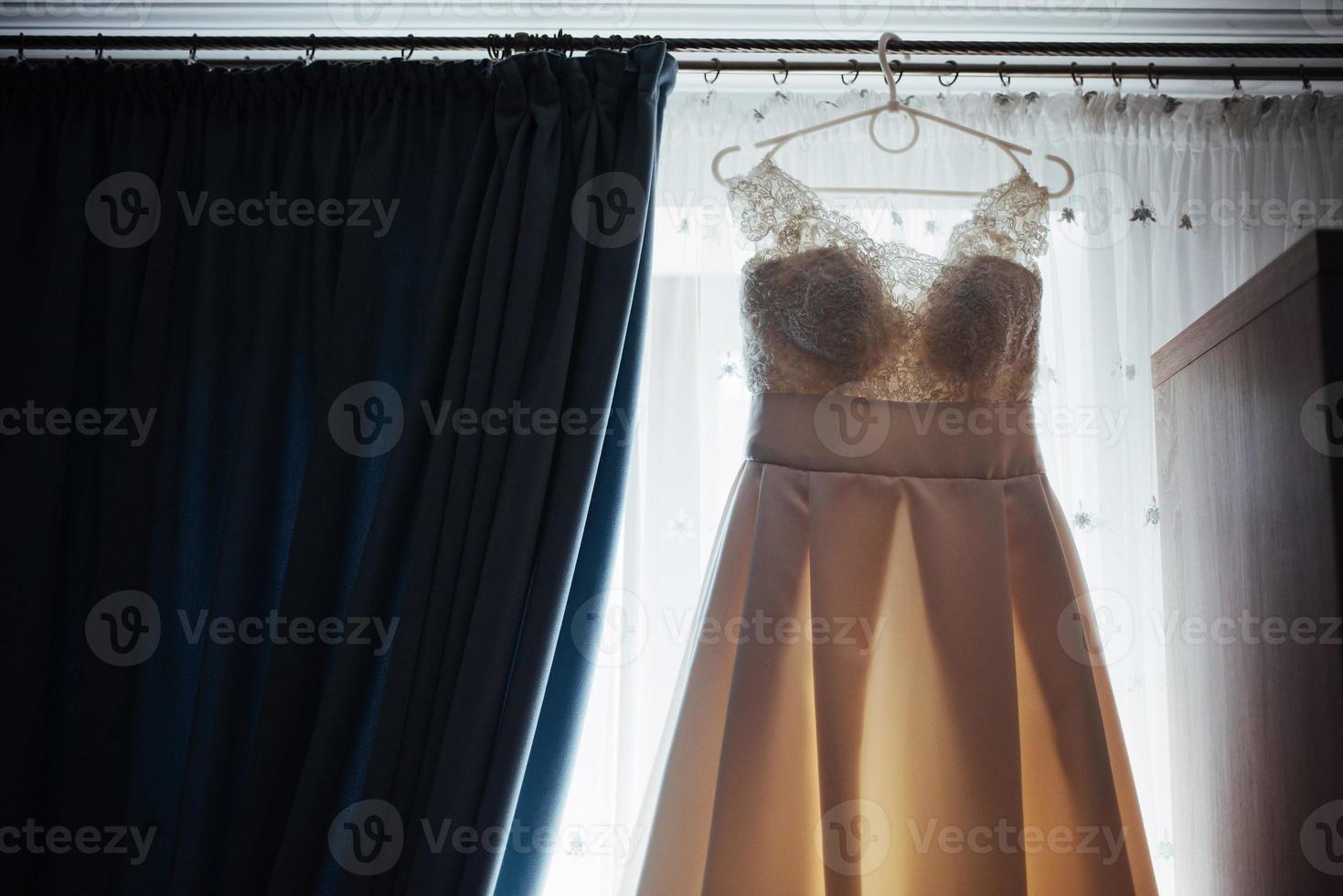 The perfect wedding dress with a full skirt on hanger photo