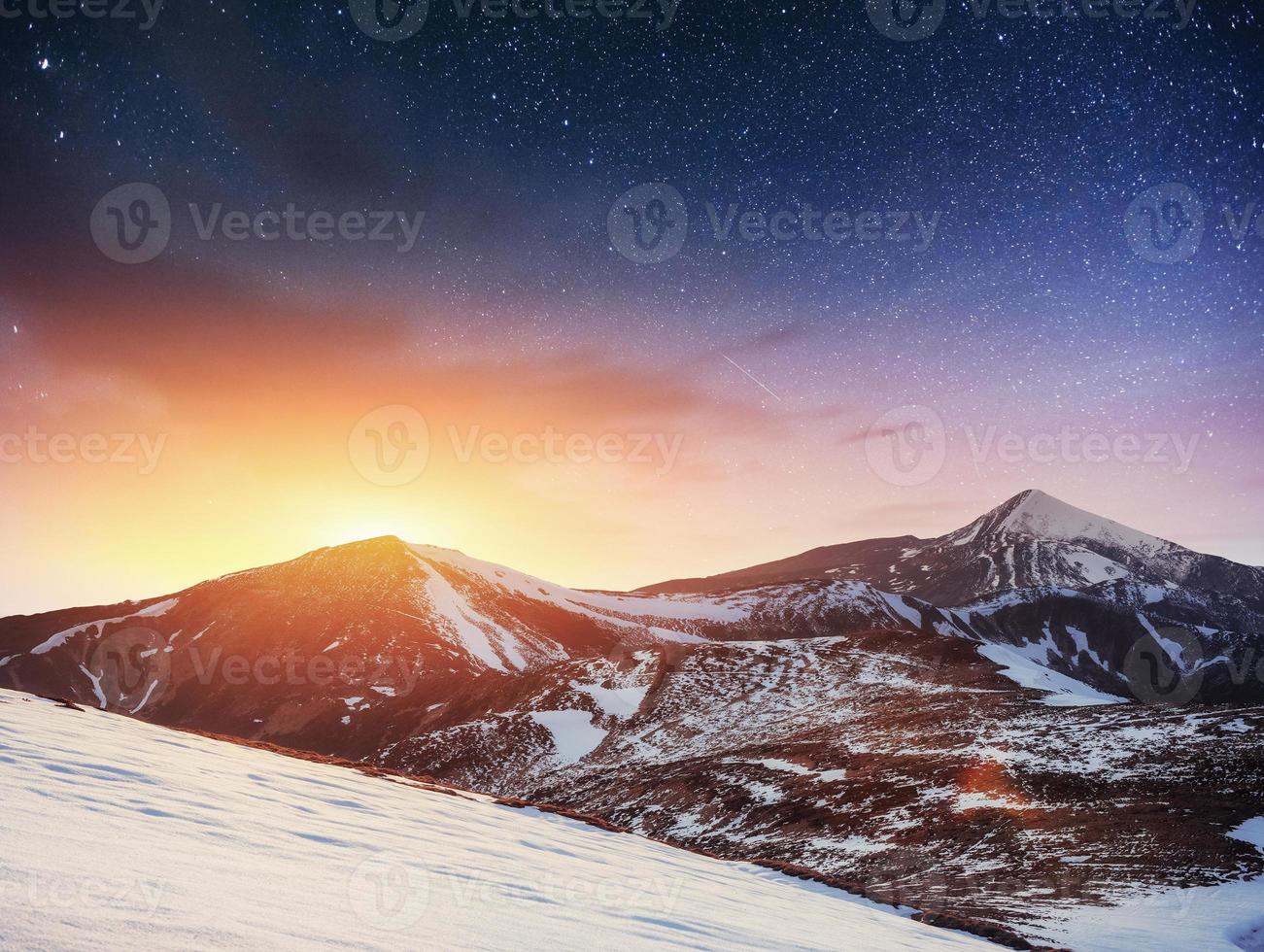 fantastic winter meteor shower and the snow-capped mountains photo