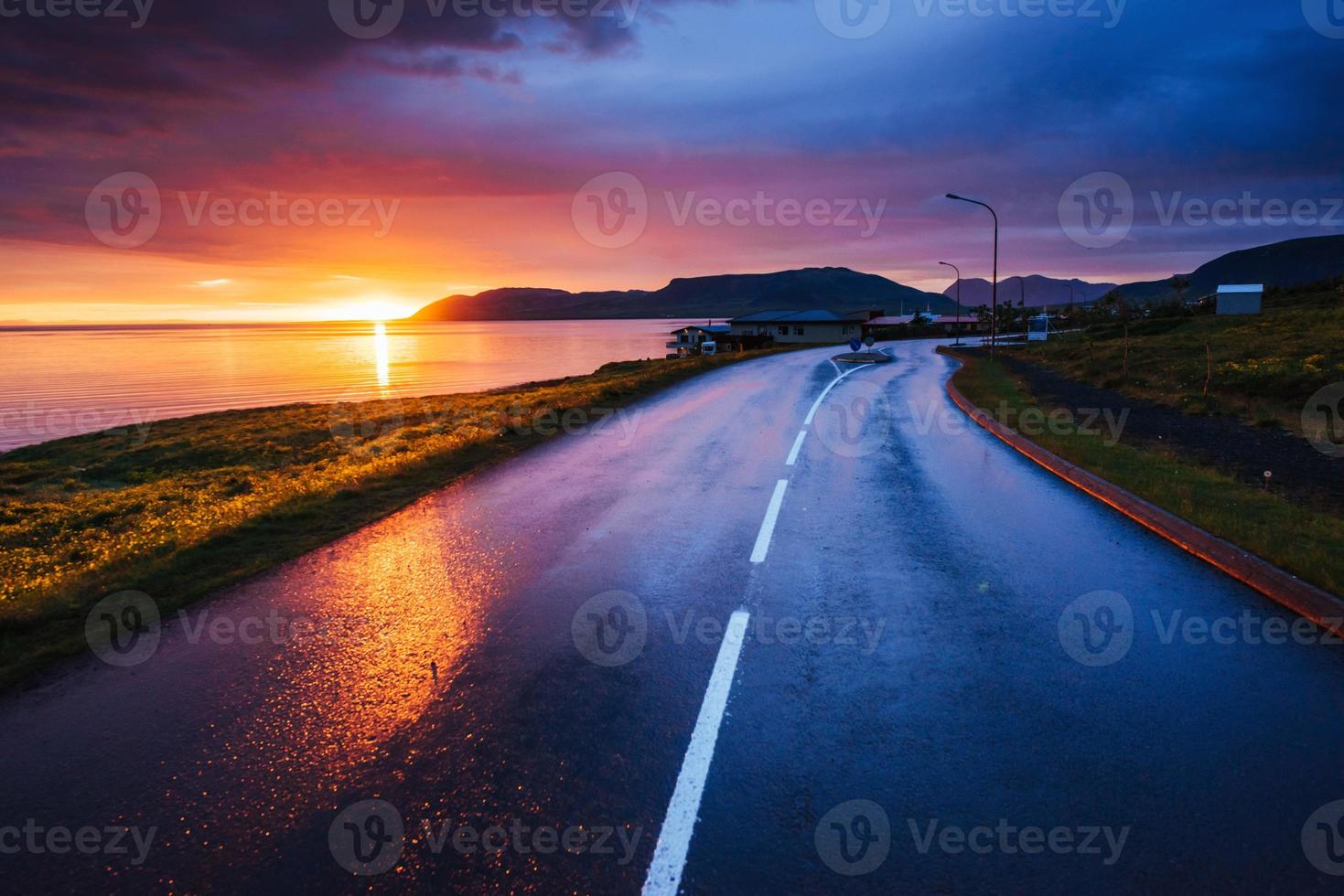 Asphalt road along the sea at sunset Iceland photo