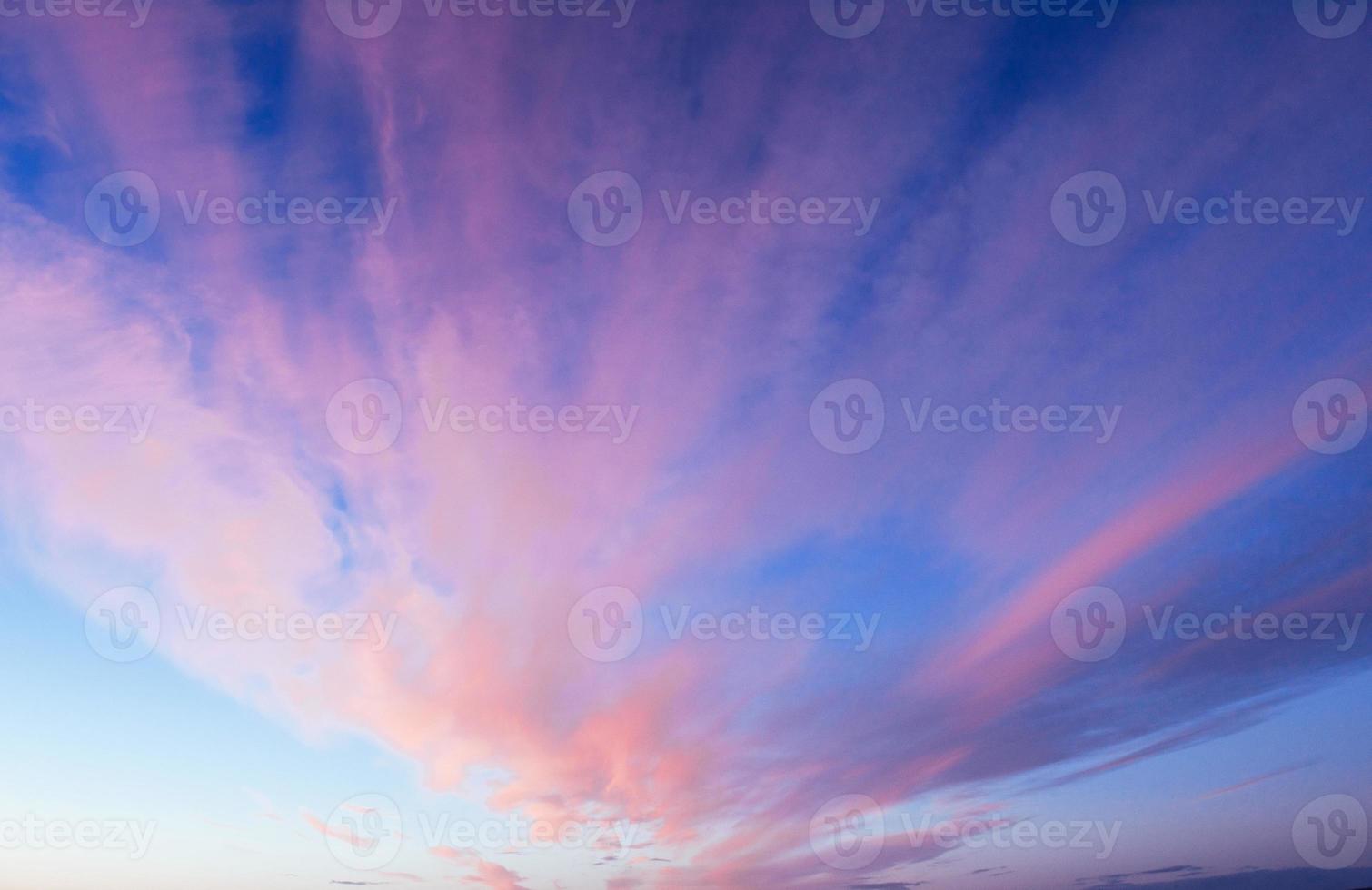 Pink orange clouds on the blue sky photo