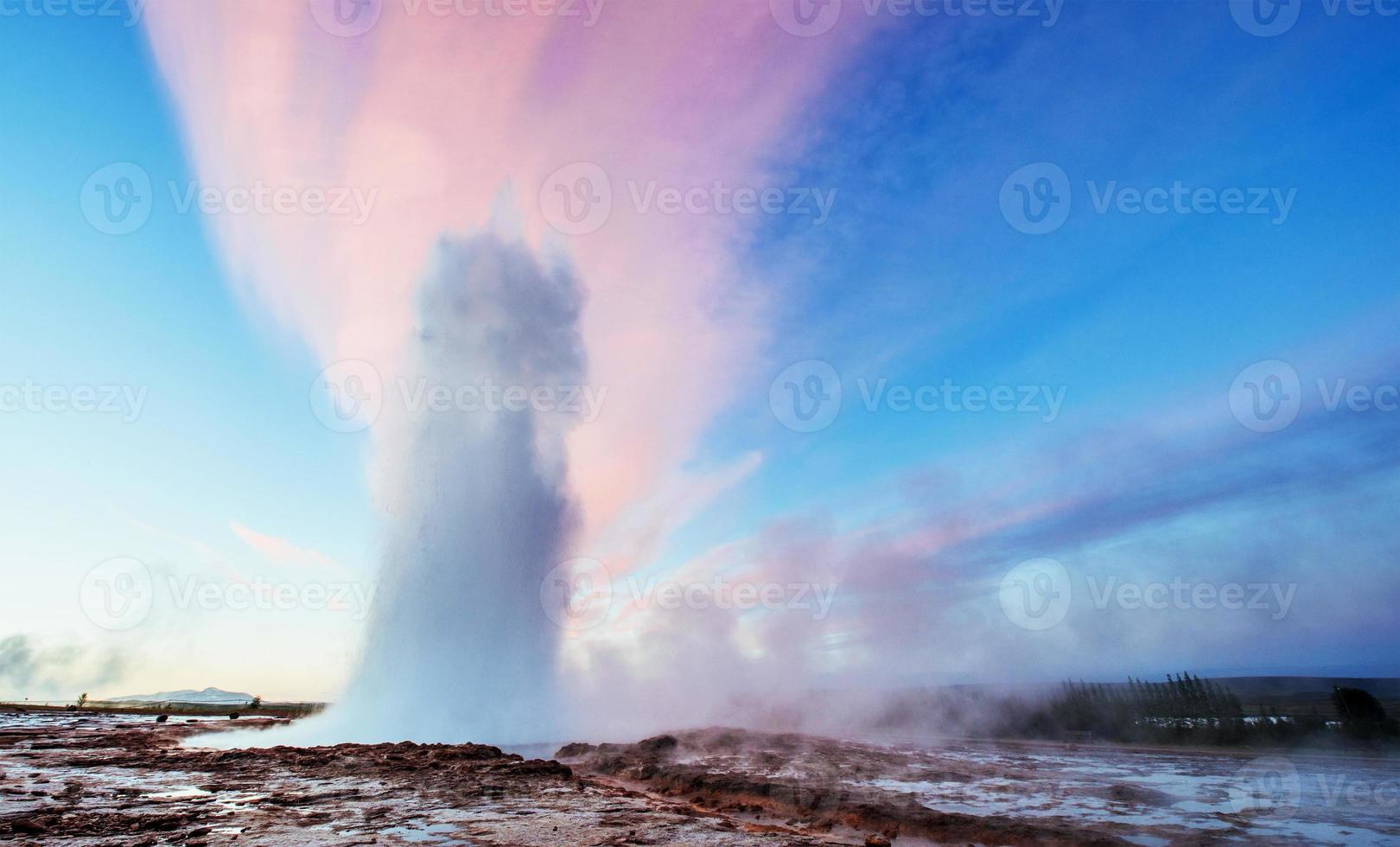 Strokkur geyser eruption in Iceland. Fantastic colors shine thro photo