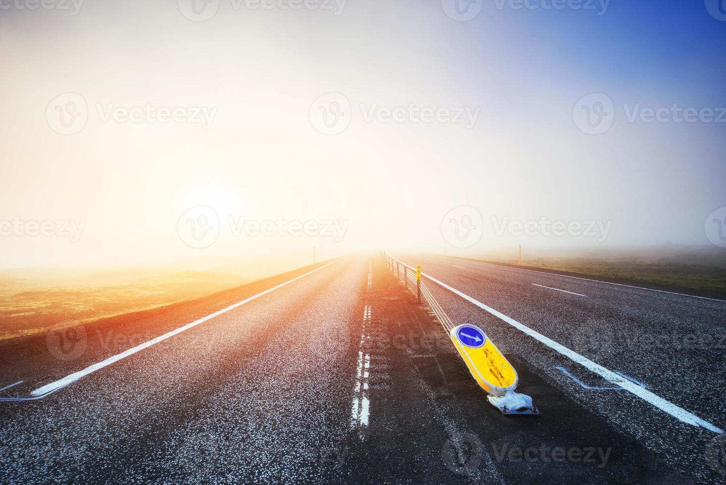 Road in mountains. Thick fog at sunset. Iceland photo