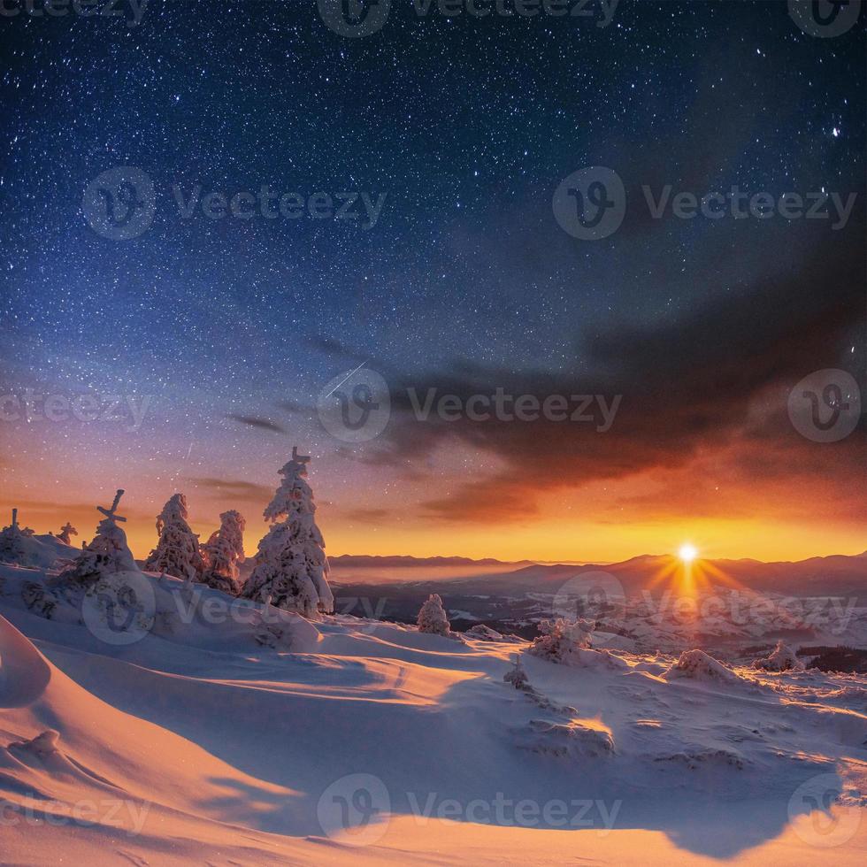 starry sky in winter snowy night. fantastic milky way in the New photo