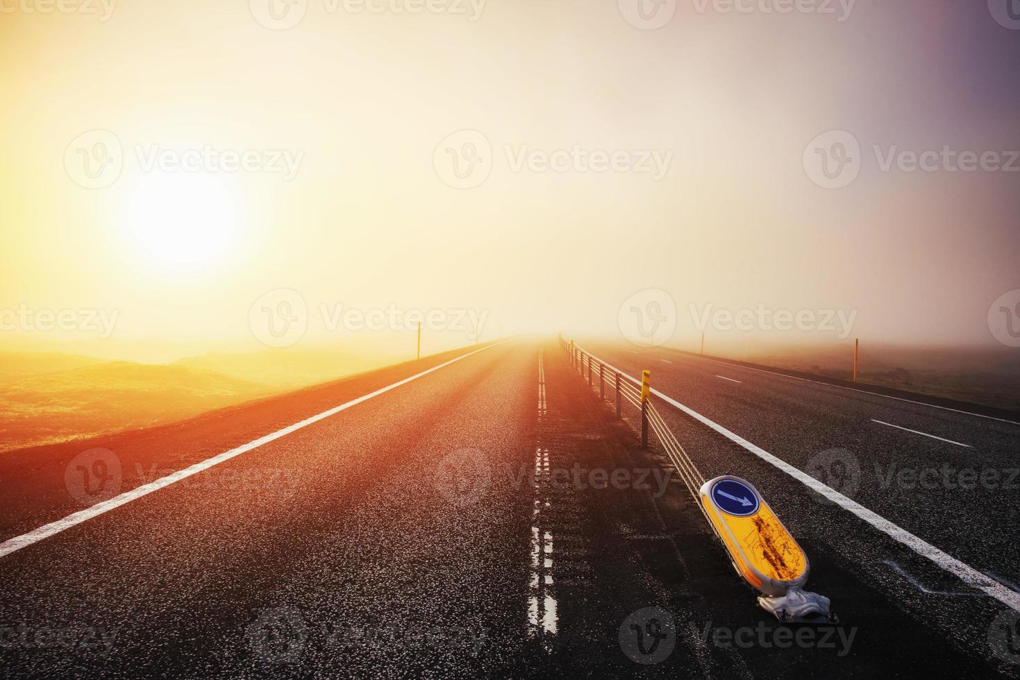 Road in mountains. Thick fog at sunset. Iceland photo