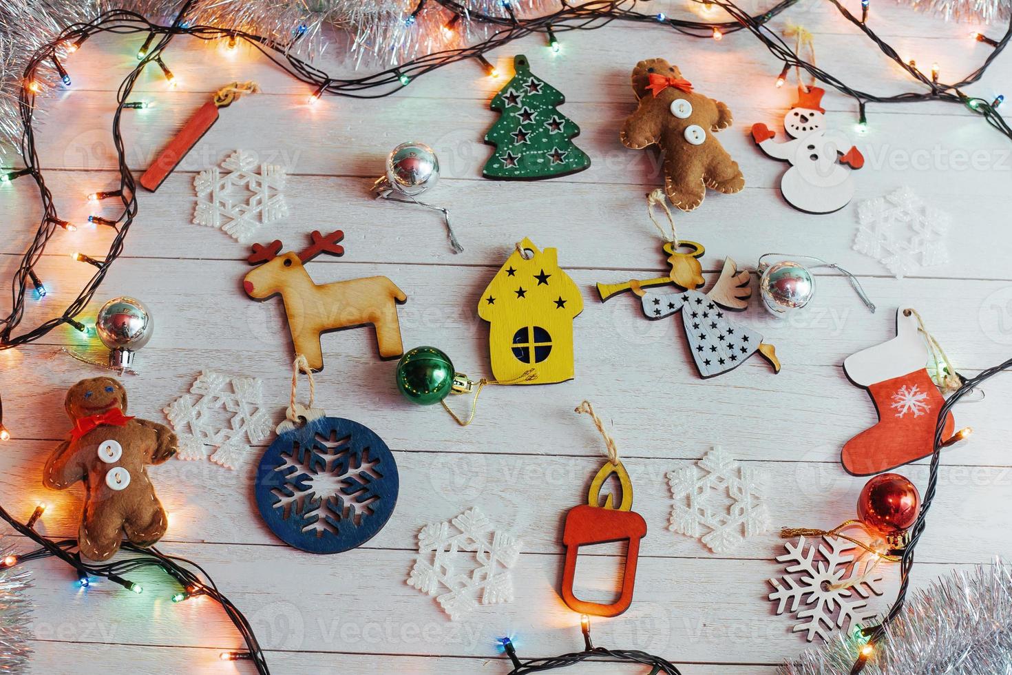 Christmas ornaments and garland lights on wooden white backgroun photo
