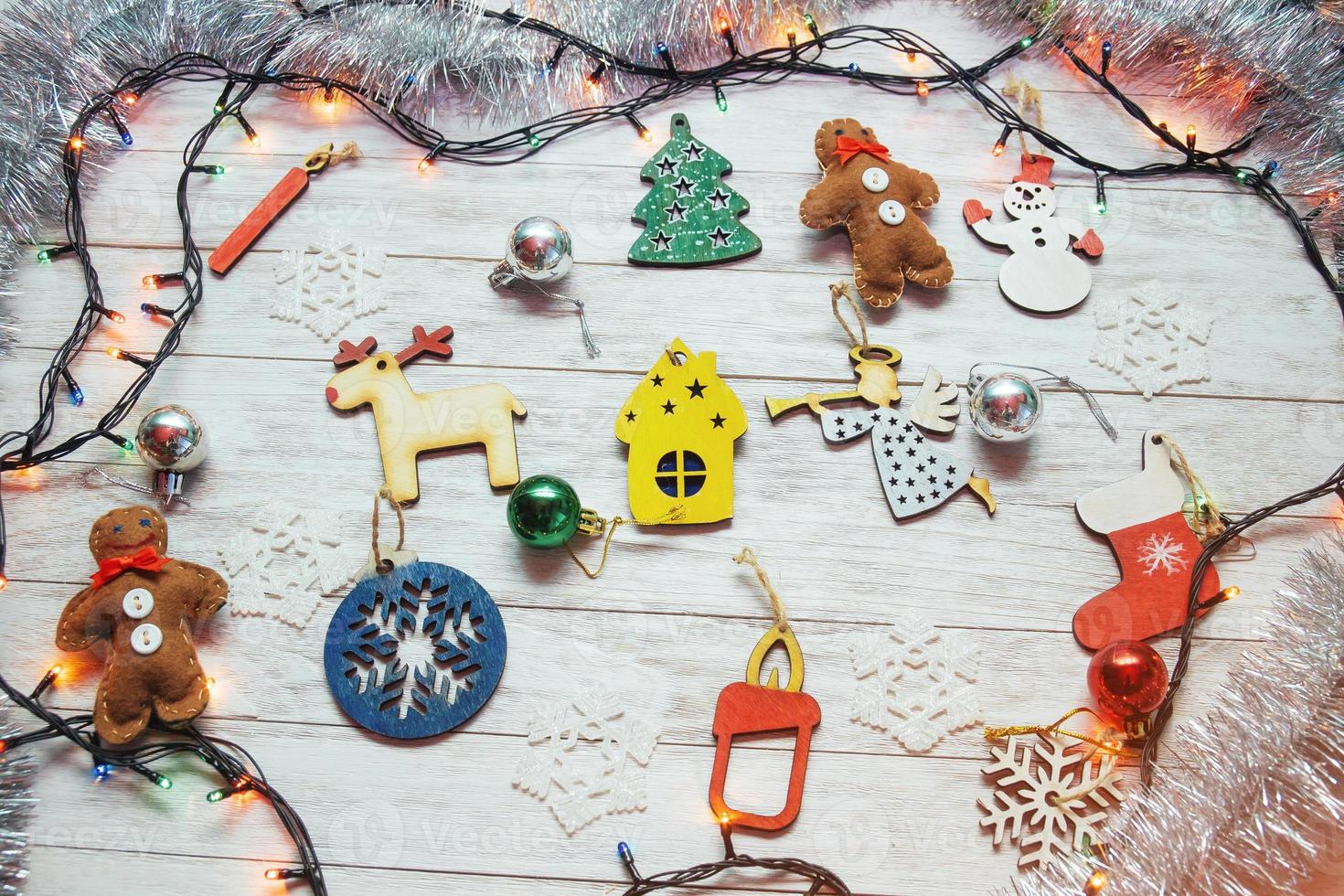 Christmas ornaments and garland lights on wooden white backgroun photo
