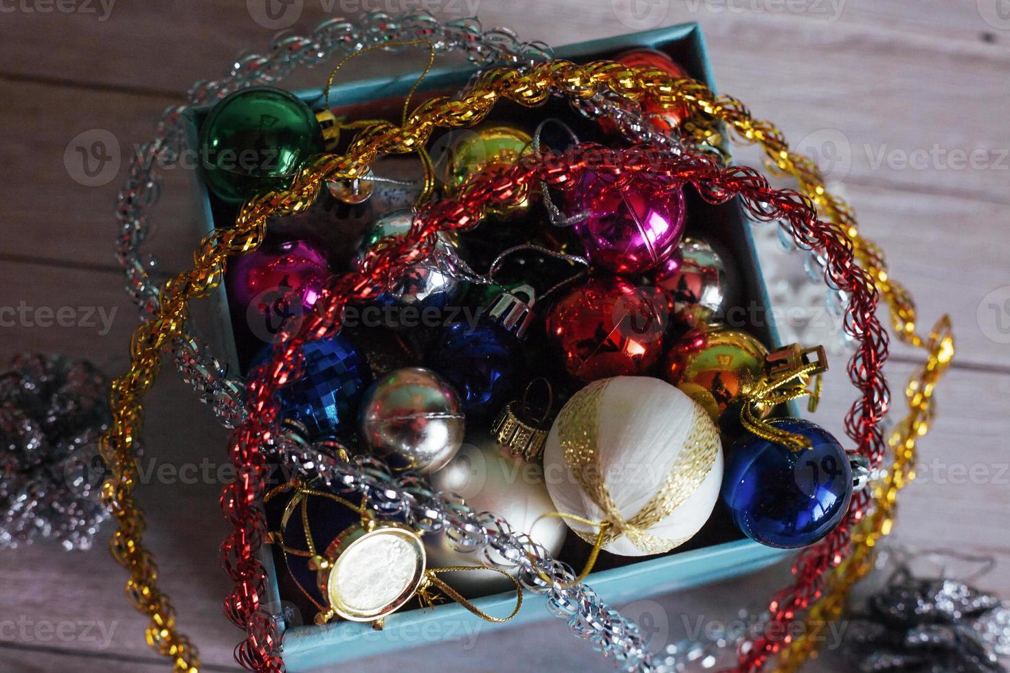 Paper box filled with colorful Christmas decorations, isolated o photo