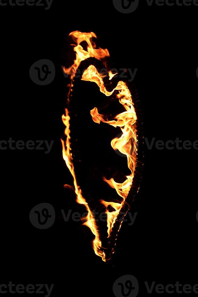 Burning heart with flames. Isolated on dark background. fire show in night. happy valentine's day card. bengal fire burning heart. space for text. wedding or valentine concept. happy new year photo