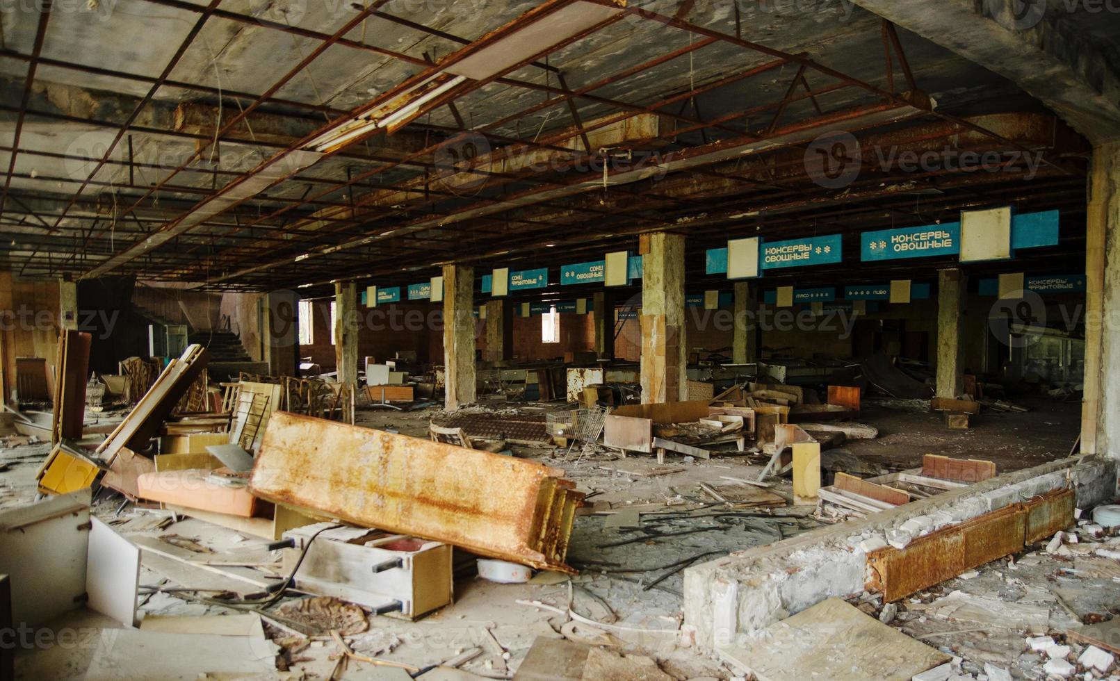 Supermarket shop at Chernobyl exclusion zone with ruins of abandoned pripyat city zone of radioactivity ghost town. photo