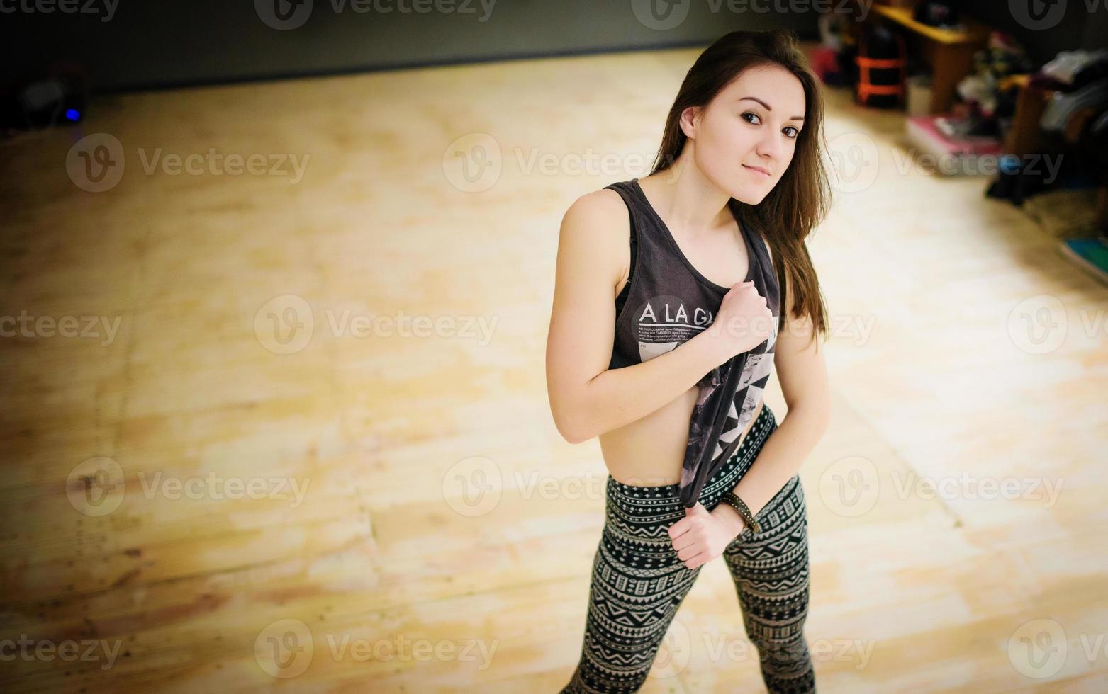 Street dancer girl wearing casual clothes on footless background wooden parquet indoor. photo