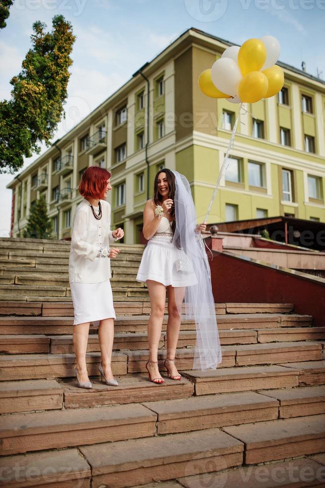 Two girls with balloons at hand on hen party. photo